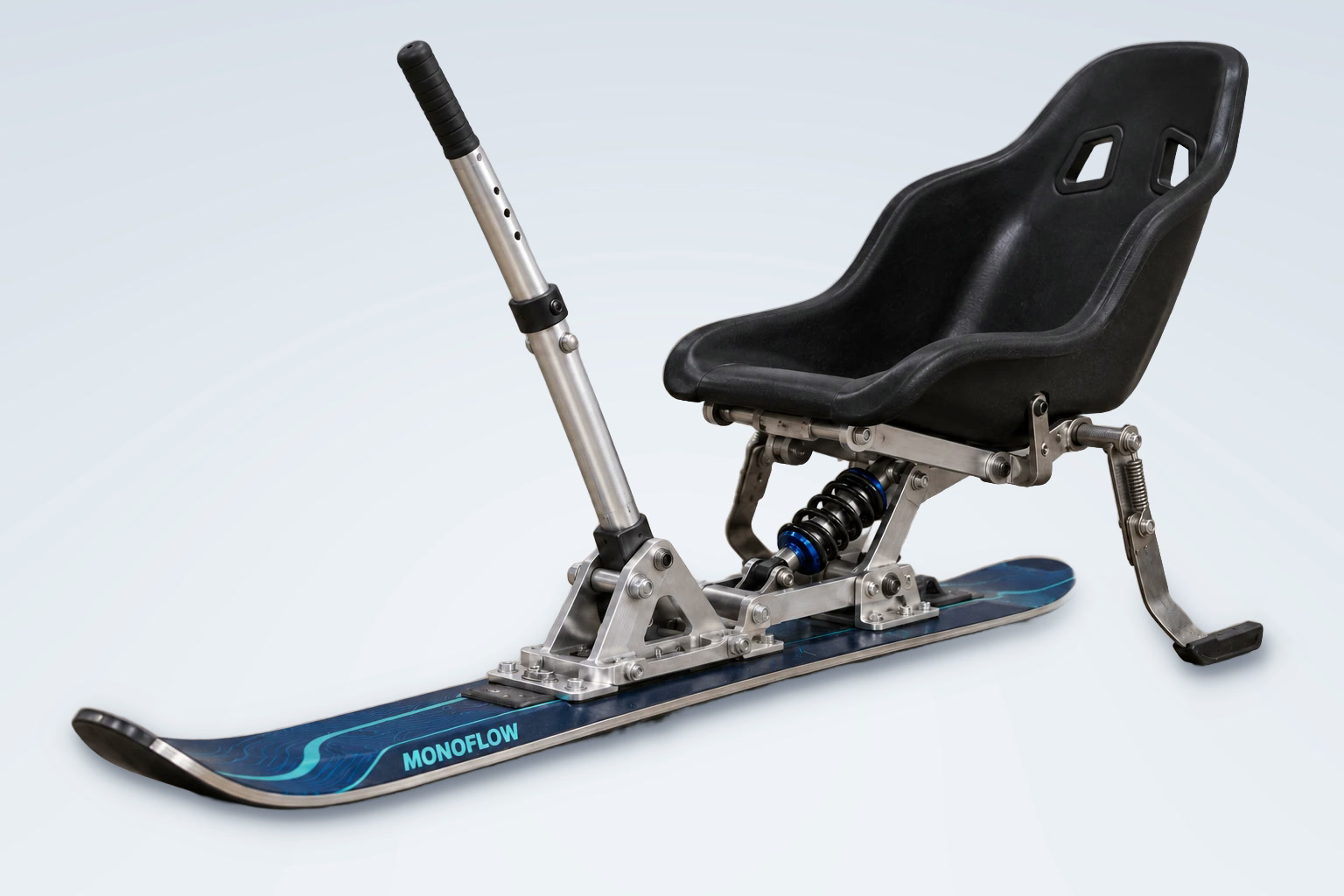 The Monoflow prototype: black bucket seat, aluminum frame and handle, coil shock and spring brake arm on a navy ski.